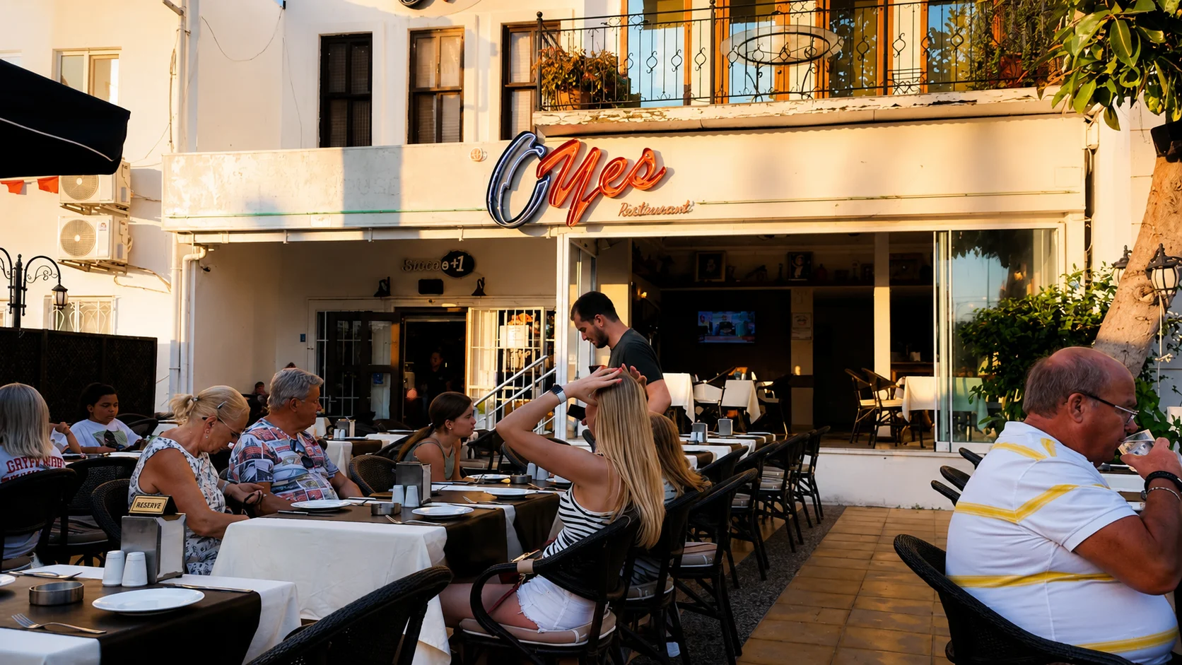 Oyes Restaurant outdoor terrace with neon sign
